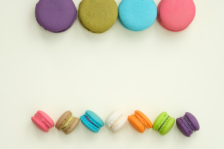 colorful macaroons on yellow background, Sweet and tasty for cooking and restaurant menu, Dessert, Top view, Space to write. pastel colors, vintage card.の写真素材