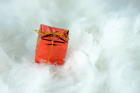 Christmas background with a red gift box and white snowの写真素材