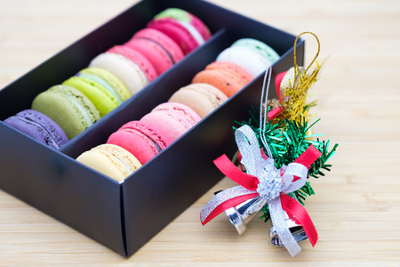 Sweet and colorful macaroons cookies in the black box on wooden background with blank space,selective focus, Dessert.の写真素材