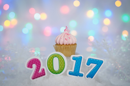 2017 Happy New Year Cupcakes on ice with bokeh background.