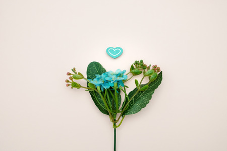 Blue plastic flowers on pink background.の写真素材