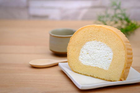 Vanilla roll cake on wooden background, AF point selection.