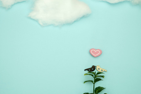 Wooden bird and a heart-shaped  on blue background with copy space for write and valentine concept.の写真素材
