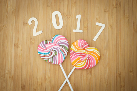 2017 alphabet letter numeric number and lollipop candy on black background. Vintage tone.の写真素材