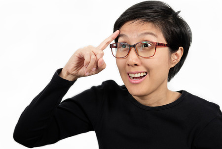 Woman wearing glasses thinking with her finger raised and have a happy expression isolated on white...