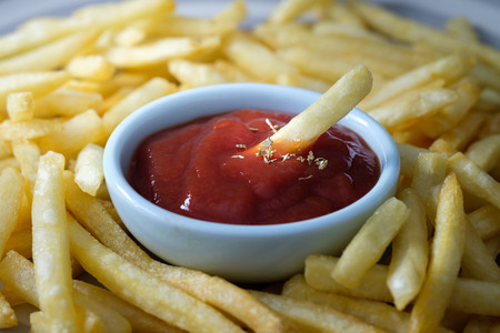 Fresh fried french fries with ketchup on ceramic dish. Choose focus point.の写真素材