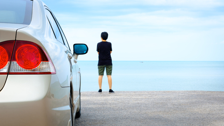 Golden car parked at the blue sea.の写真素材