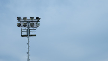 Spotlight of football stadium on blue sky blackground.の写真素材