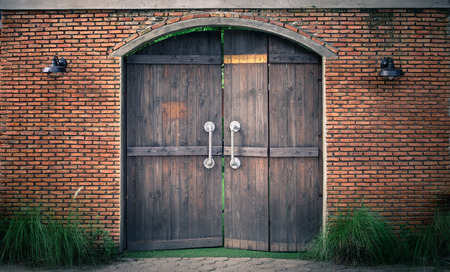 Old and mysterious doors are made of wood, The door handle is a steel rod for pulling and pushing.の写真素材