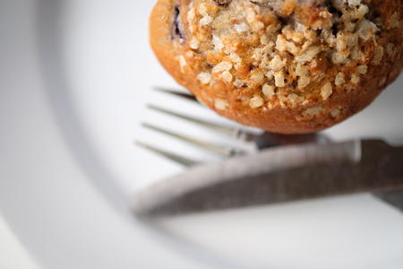 A delicious muffin cake is placed on a white plate.の写真素材