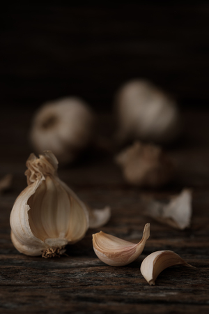 Still life of garlic bulb in dark black background with copy space, It is a herbal food popular Asian.の写真素材