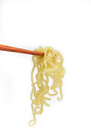 Instant noodles on chopstick isolated on white background, junk food or fast food concept.の写真素材