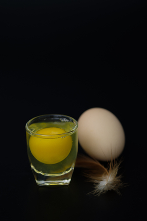 Still life-Eggs and yolks in glass arranged in a black scene, Egg is beneficial to the body, Food concept. dark tone.の写真素材