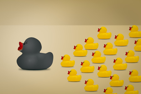 Rubber ducks in  leadership concept on a yellow background.の写真素材