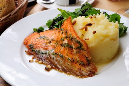 grilled salmon and lemon - french cuisine dish with tomato and salmonの写真素材