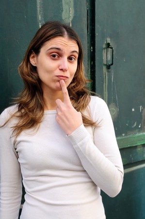 Outdoor portrait young woman with green wooden doorの写真素材