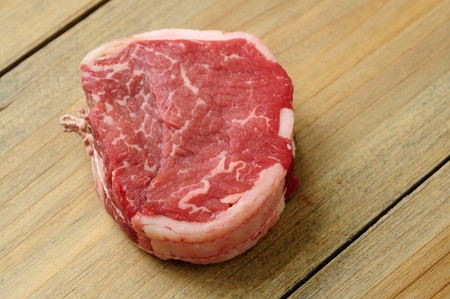 Raw meat-isolated raw beef on the wooden table  の写真素材