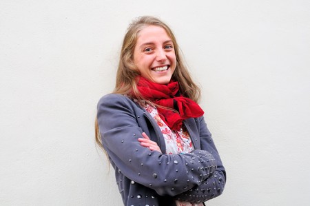 Outdoor portrait young woman with  white wall