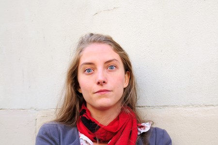 Outdoor portrait young woman with  white wallの写真素材