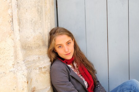 Outdoor portrait young woman with white wooden doorの写真素材