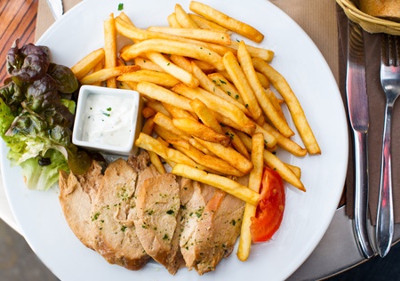 Fresh chicken steak with tomatoes and french fries の写真素材
