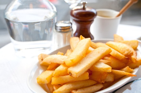 Golden French fries potatoes ready to be eatenの写真素材