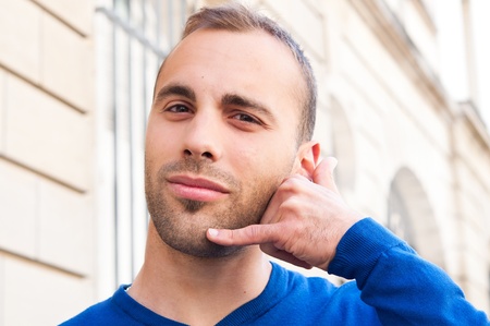 Outdoor portrait young men talk on a cellular telephone の写真素材