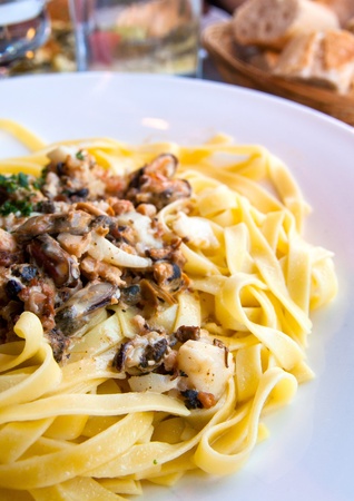 close-up of plate of pasta and seafood with lettuceの写真素材
