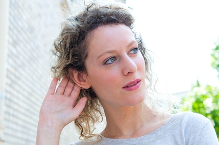 Relying on hand-ear listening in the streets of Parisの写真素材