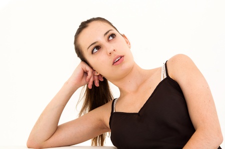 Portrait of a thinking woman looking upの写真素材