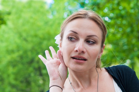 Relying on hand-ear listening in the streets of Parisの写真素材