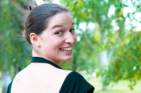 beautiful young attractive woman outdoors portrait  in the green grassの写真素材