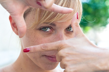 Young woman is focused view in the green grassの写真素材