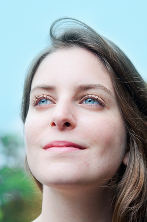 beautiful young attractive woman outdoors portrait of thinking womanの写真素材