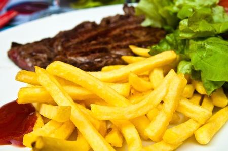 juicy steak beef meat with tomato and french friesの写真素材