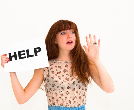 NEED HELP? portrait young woman with board HELPの写真素材