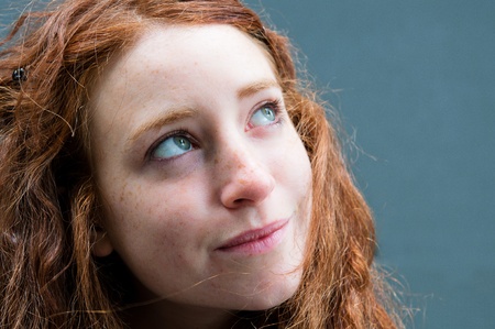 beautiful young attractive woman outdoors portrait of thinking womanの写真素材