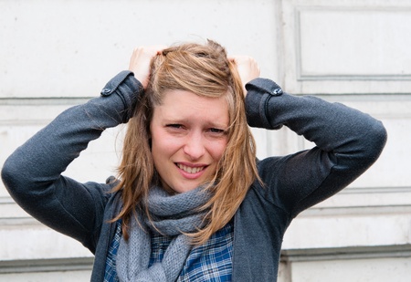 Young panic woman with hands on the headの写真素材