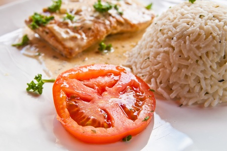 grilled salmon and rice-french cuisine dish with tomato and salmonの写真素材