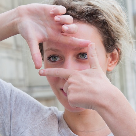 Young woman is focused view in the viewfinder gesturesの写真素材