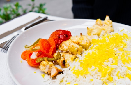 Rice and chicken on white plateの写真素材