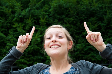 attractive young woman with her finger upの写真素材