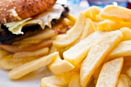 American cheese burger with golden French fries potatoesの写真素材