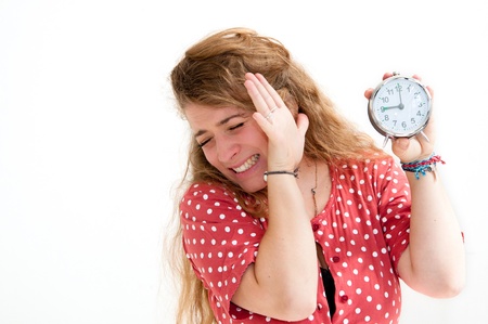 beautiful young woman holding alarm clock