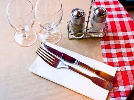 place setting - plate, knife and fork on table