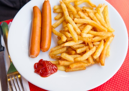 Grilled sausage served with french friesの写真素材