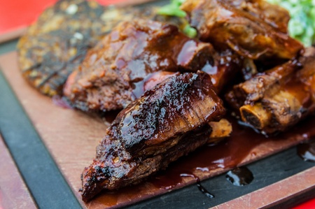 Grilled steak - Grilled meat ribs on the plate with hot sauceの写真素材