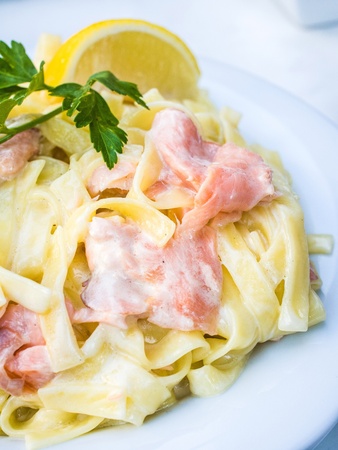 tasty pasta with salmon on a the tableの写真素材