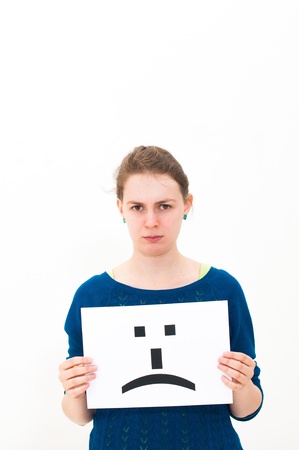 portrait young woman with board sad emoticon face signの写真素材