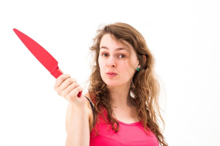 Woman with a knife on a white backgroundの写真素材